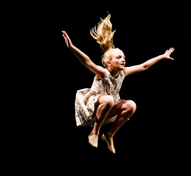 girl leaping in air while dancing
