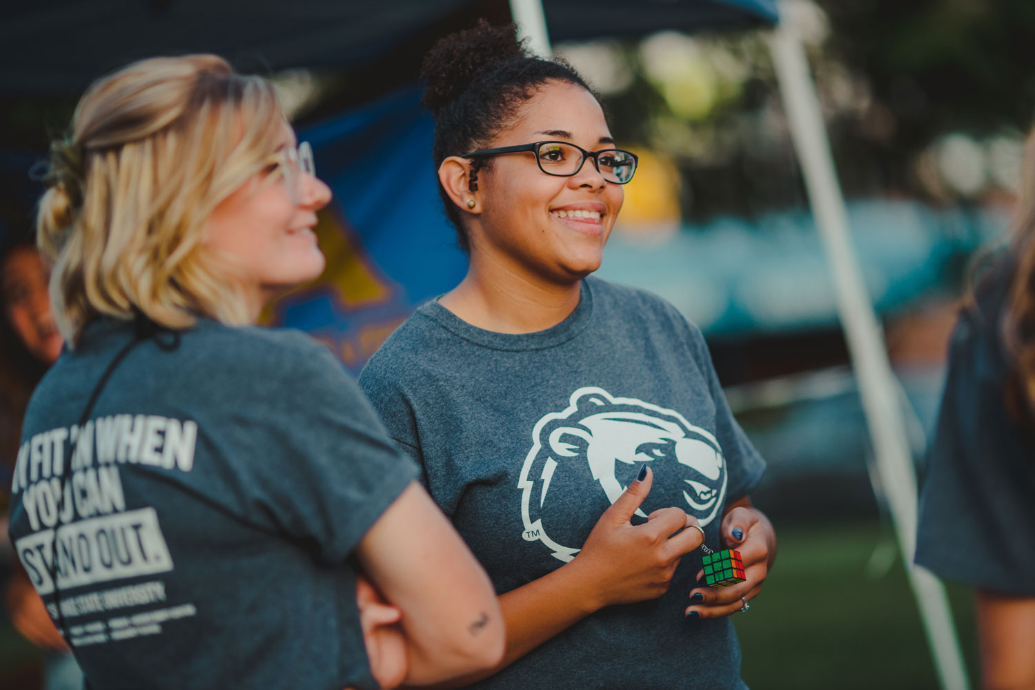 student in Bear shirt by tent