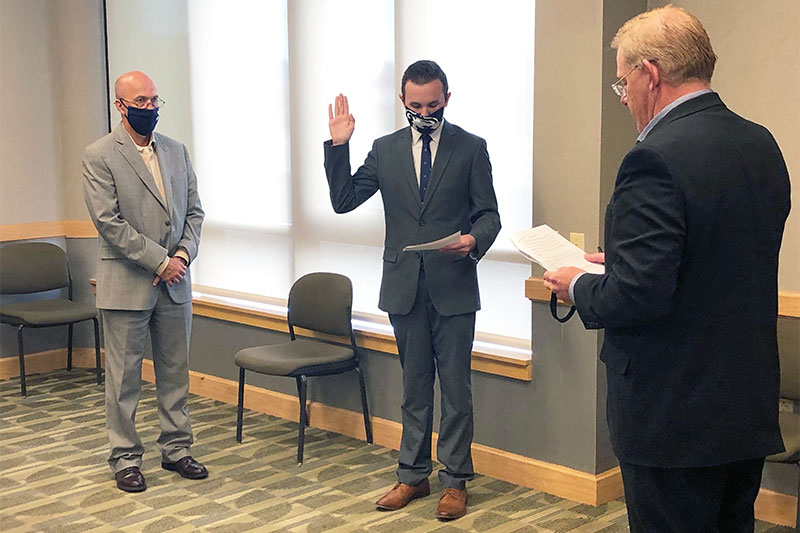 Eli Cole being sworn in as a Student Trustee