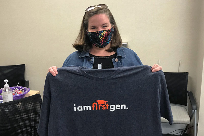 Marcie Simms holding a First Gen t-shirt