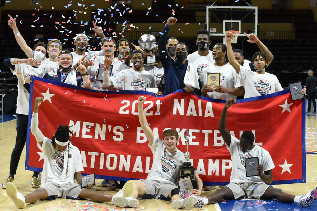 Men's basketball team with national championship banner