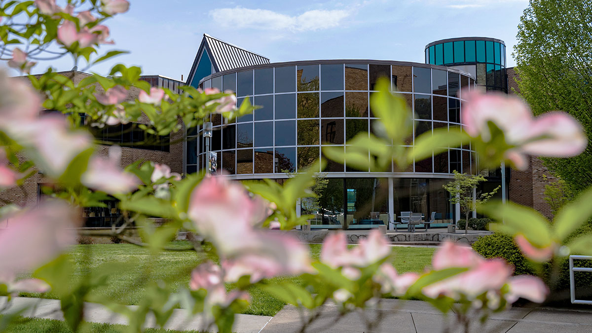 Image of SSU Morris University Center with flowers in the foreground