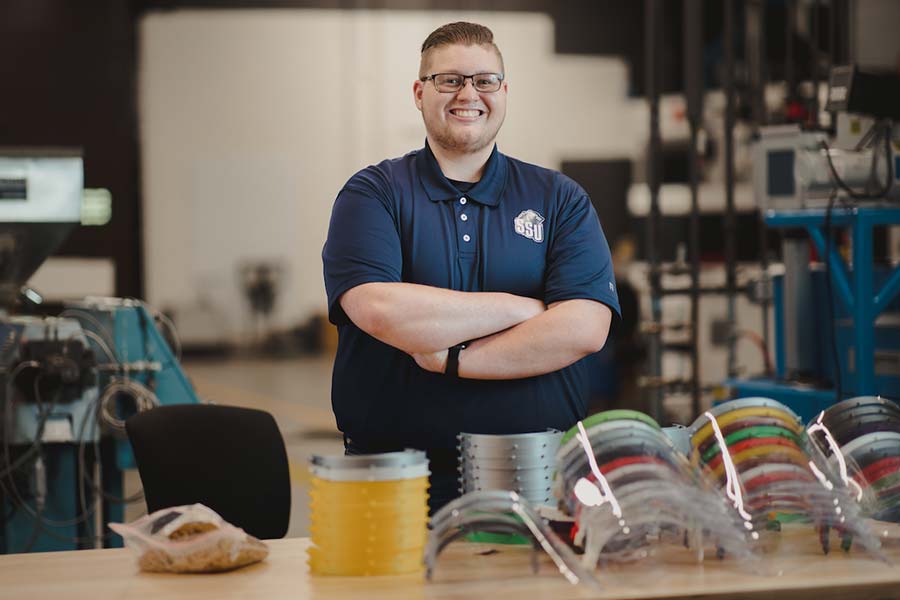 Nathan Dever posing in Plastics lab