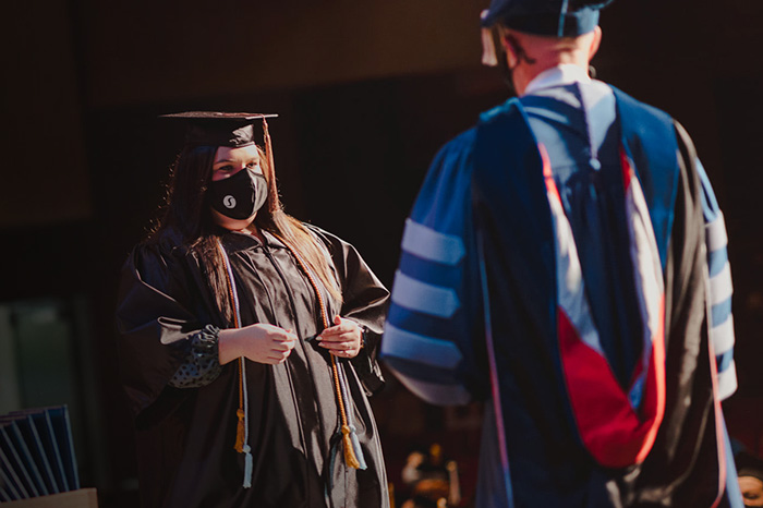 photo of woman receiving degree on stage