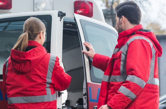 female and male EMTs with ambulance