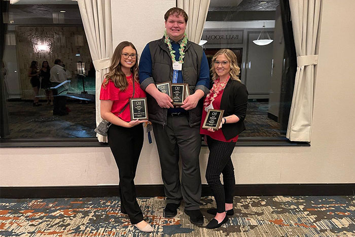 students posing with awards