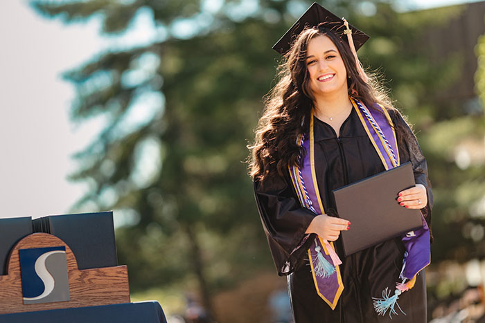 woman walking with diploma