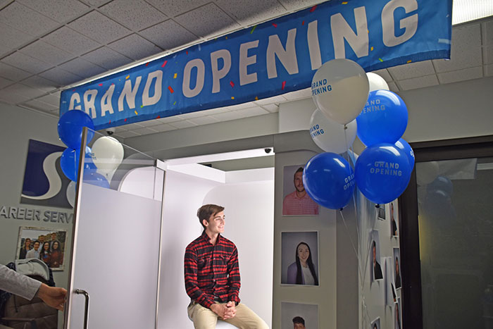 student posing in photo booth