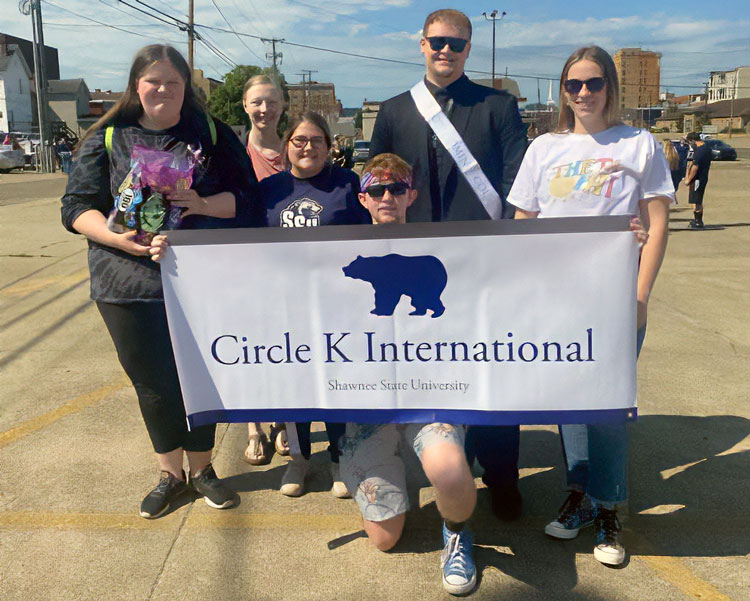 Circle K club members holding sign