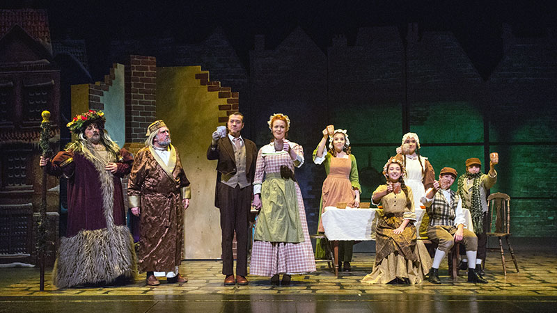 A Christmas Carol actors performing on stage
