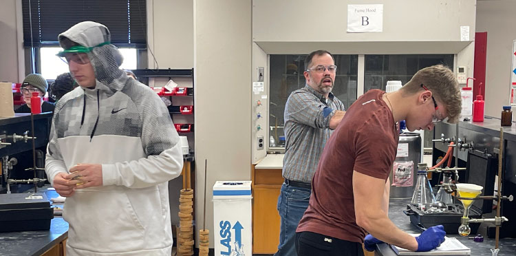 Derek Jones with students in lab