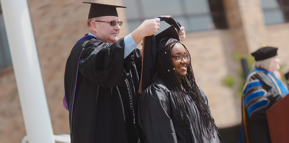 Destiny Dotson is hooded in recognition of the completion of her Master of Business Administration degree