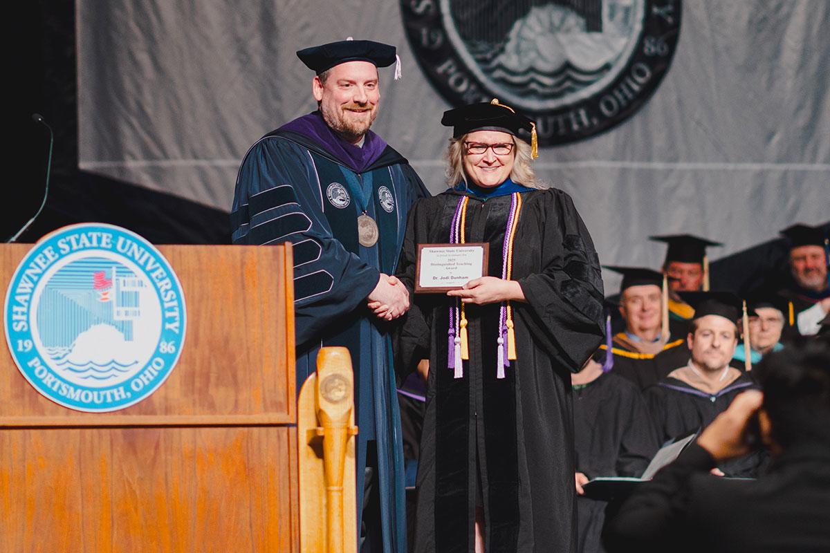 Dr. Jodi Dunham receives the Shawnee State University Board of Trustees Distinguished Teaching Award from SSU President Eric Andrew Braun