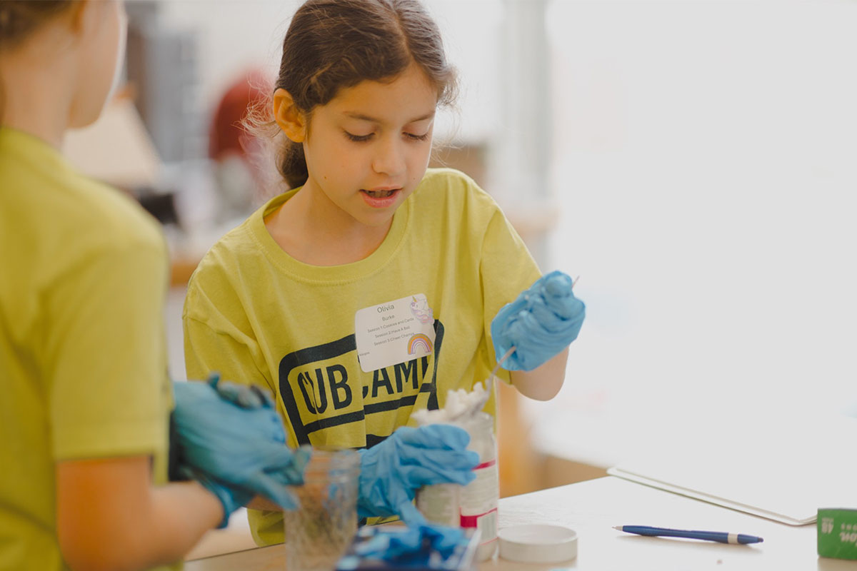 girl doing science activity at summer camp