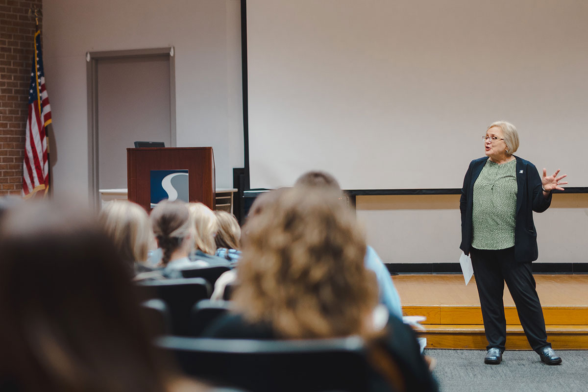 Dr. Christine Raber addresses students