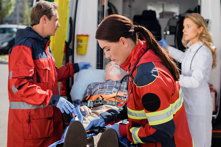 paramedics loading person onto ambulance
