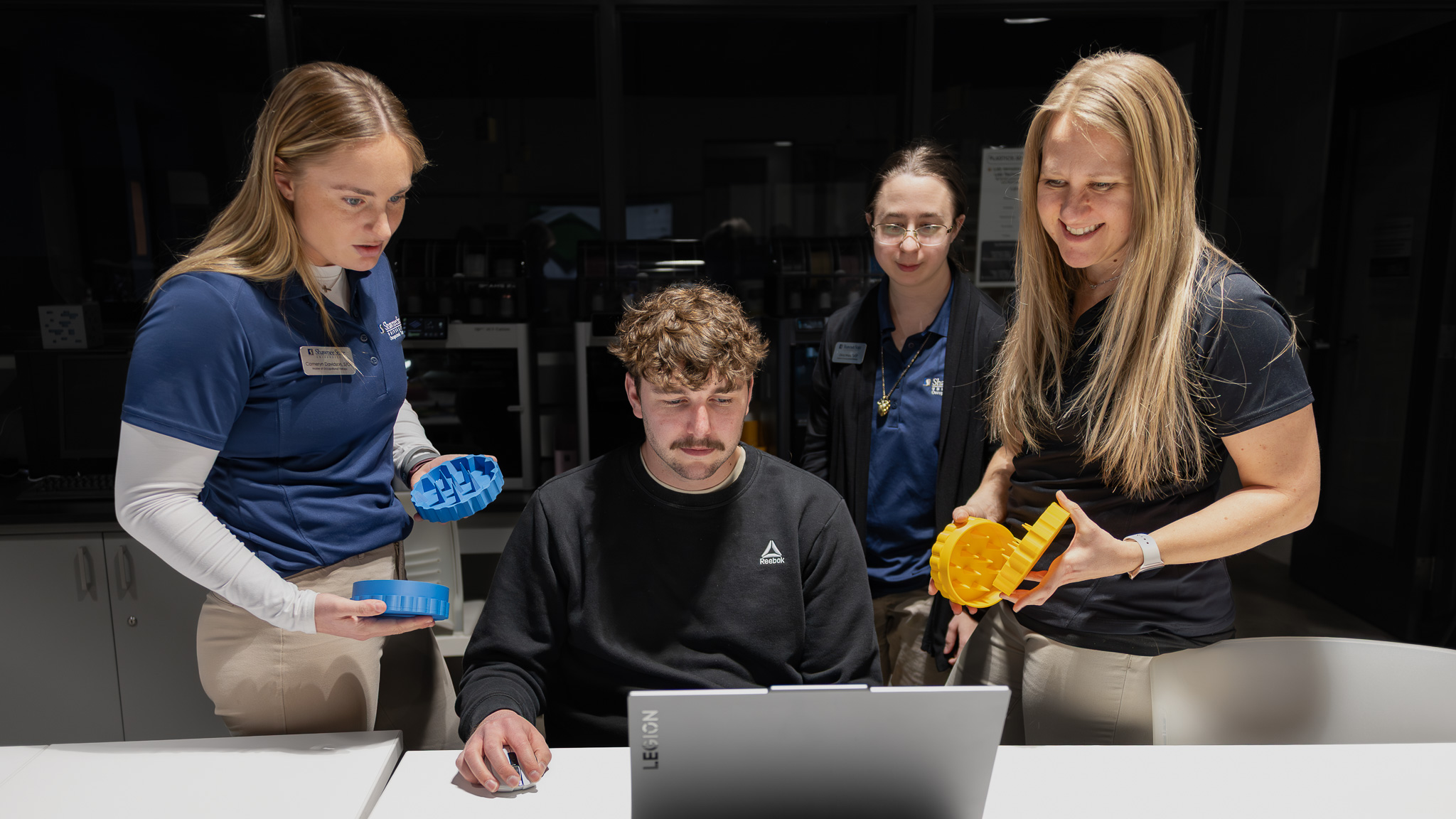 SSU students collaborating on a 3D-printed assistive device.