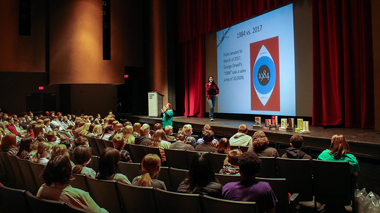 students in theater watching presenter