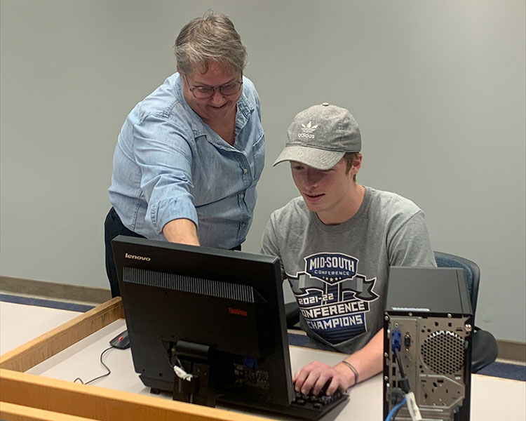two people looking at computer screen