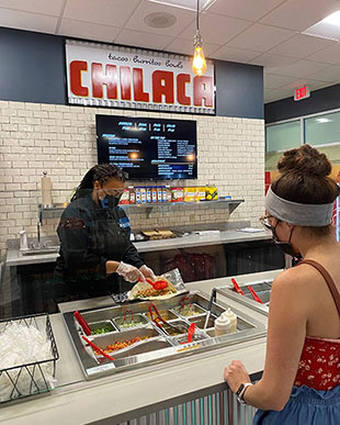 Student watching her food being prepared