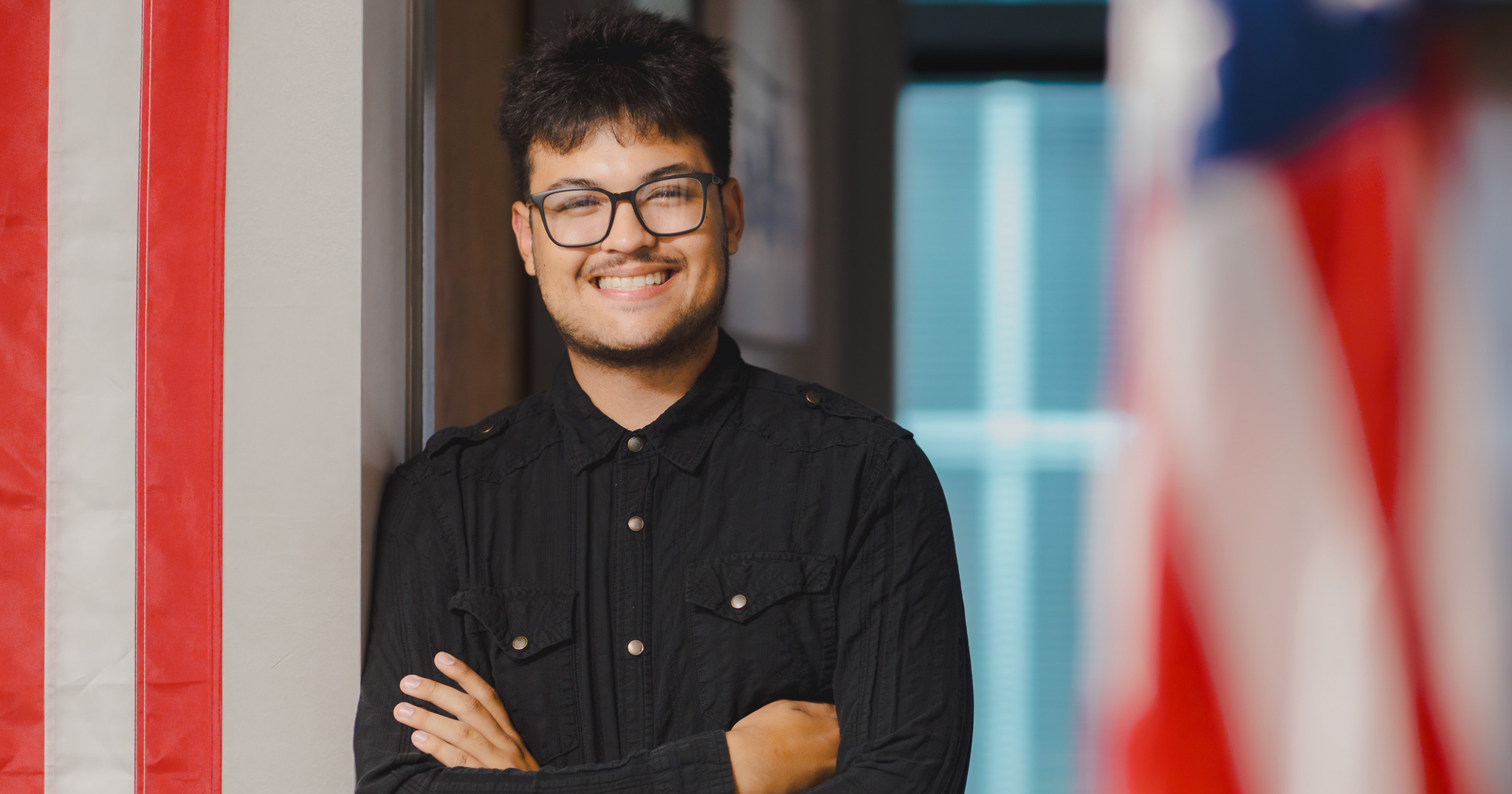 Man standing near American flags
