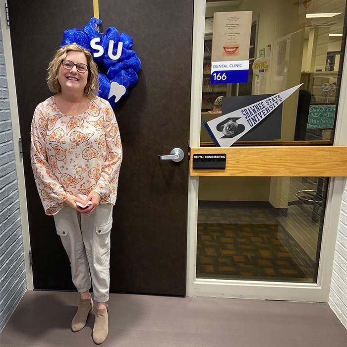 woman standing in front of clinic entrance