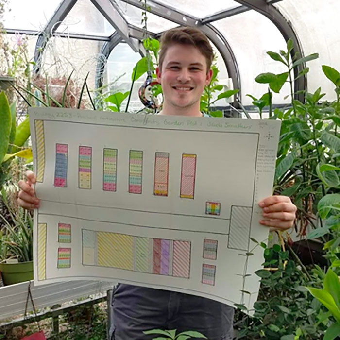 Jacob Smathers holding his garden plot design