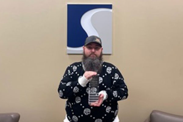 Jay Helsel holding award