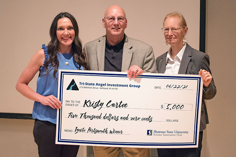 Kristy Cartee receiving check