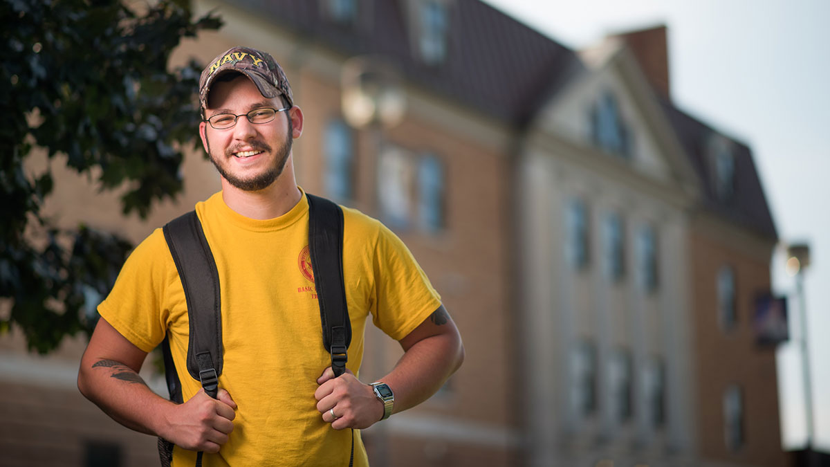 male student smiling on campus