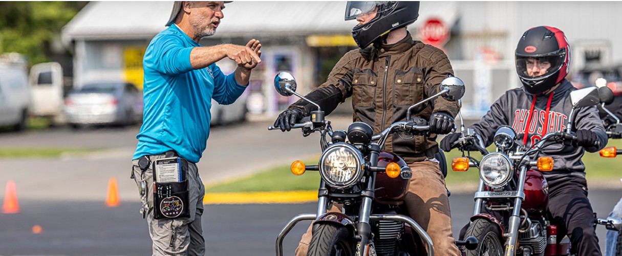 Motorcycle instructor with students on cycles