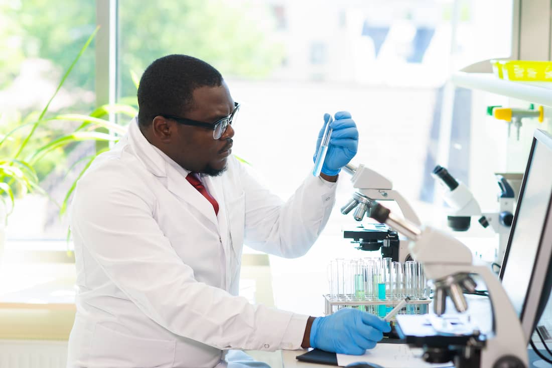 African-American doctor working in lab doing medical research. 