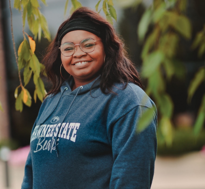 portrait of young woman smiling on campus