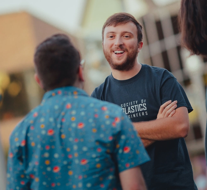 smiling student in plastics engineering shirt