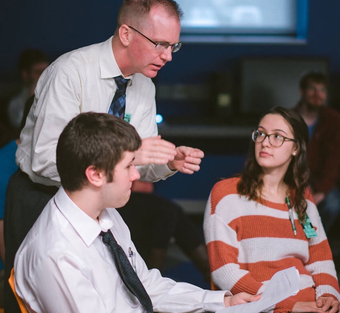 Professor with students in classroom