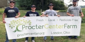 Students posing with banner