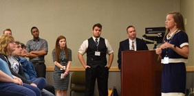 Female giving presentation to a group of students