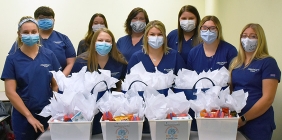 students posing with baskets