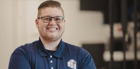 Nathan Dever posing in Plastics lab