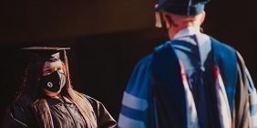 photo of woman receiving degree on stage