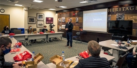 group of students watching a man speak