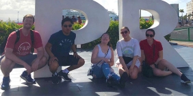 Students posing in front of sign