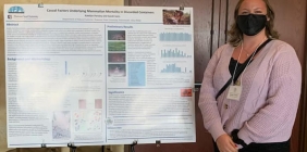 Katelyn Parsley standing beside poster