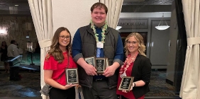 students posing with awards