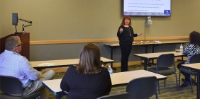 woman presenting to group in classroom