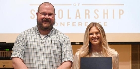 student holding award