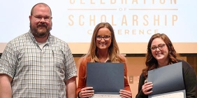 students holding awards