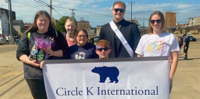 Circle K club members holding sign