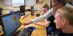 Instructor and students in plastics lab