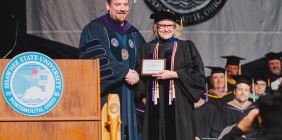 Dr. Jodi Dunham receives the Shawnee State University Board of Trustees Distinguished Teaching Award from SSU President Eric Andrew Braun